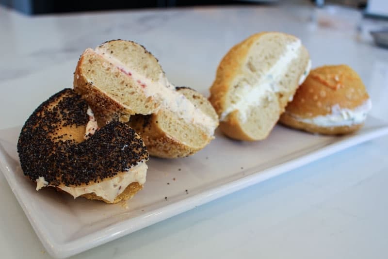 Customers can create combinations, such as the poppy seed bagel with sun-dried tomato cream cheese (left) or the asiago bagel with scallion cream cheese (right).