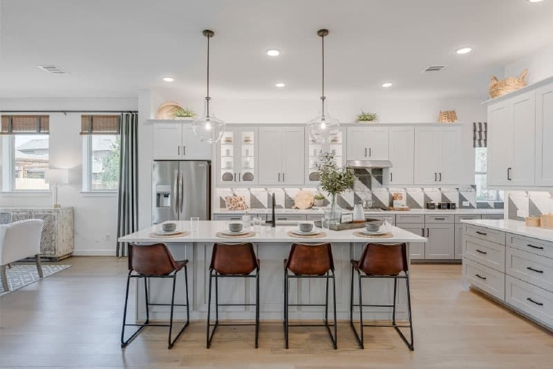 The kitchen includes 42-inch wood upper cabinets, granite countertops and a stainless steel appliance package.