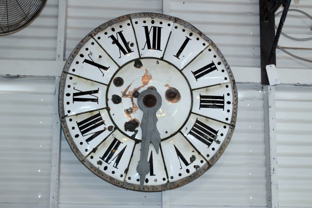 The Lyfords bought this clock at a flea market in France. It is handmade using copper and enamel. It was in a clock tower in France and has bullet holes from WWII. (Karen Chaney/Community Impact Newspaper)