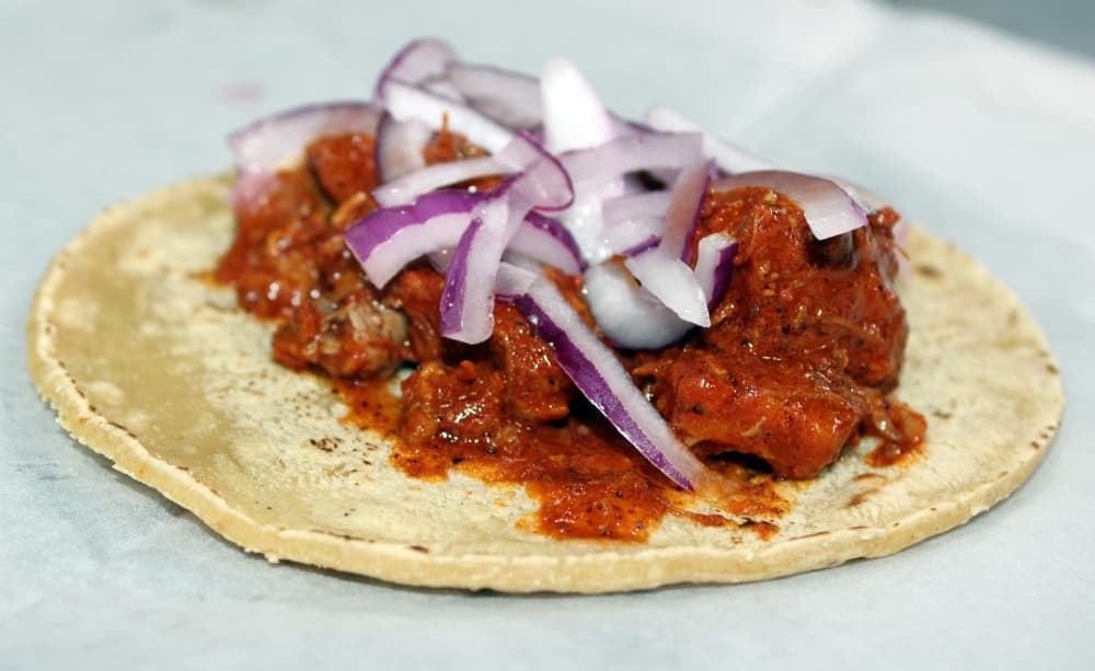 The Cochinita Pibil taco ($3.09) has baked pork with achiote sauce and pickled red onions mixed with habanero pepper. (Karen Chaney/Community Impact Newspaper)