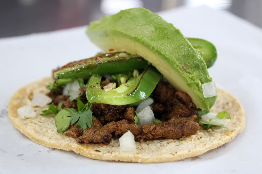 The taco Del Sur ($3.99) has a choice of pork carnitas, barbacoa, beef/carne asada or pollo, and it comes with grilled jalapeno slices, onions, cilantro and avocado. (Karen Chaney/Community Impact Newspaper)