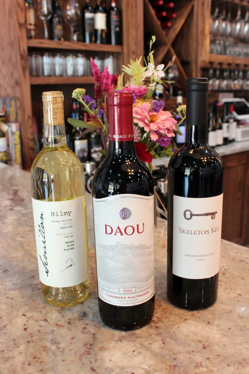 Wine:30 on Oak Street has more than 100 varieties of wine. Hilmy Cellars’ Semillon, from left, is an off-dry white wine from Texas ($12 per glass, $38 per bottle). Daou Cabernet Sauvignon is from Paso Robles, California ($12 per glass, $39 per bottle). Skeleton Key is a proprietor’s blend ($12 per glass, $34 per bottle). (Karen Chaney/Community Impact Newspaper)