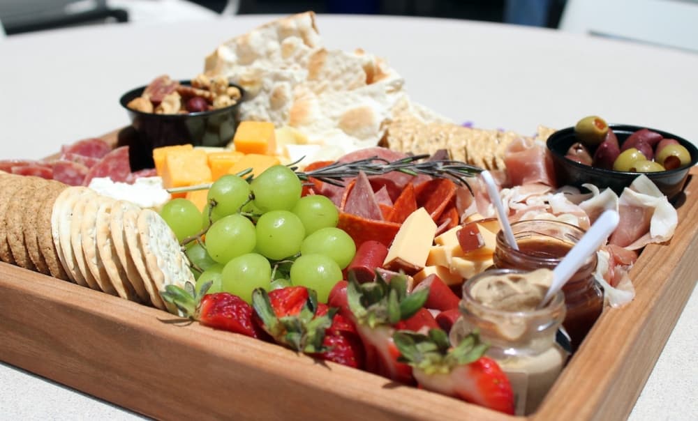 Small charcuterie boards ($20) include cheese, nuts, fruits and crackers. This large charcuterie board ($35) also features charcuterie meats and spreads. (Karen Chaney/Community Impact Newspaper)
