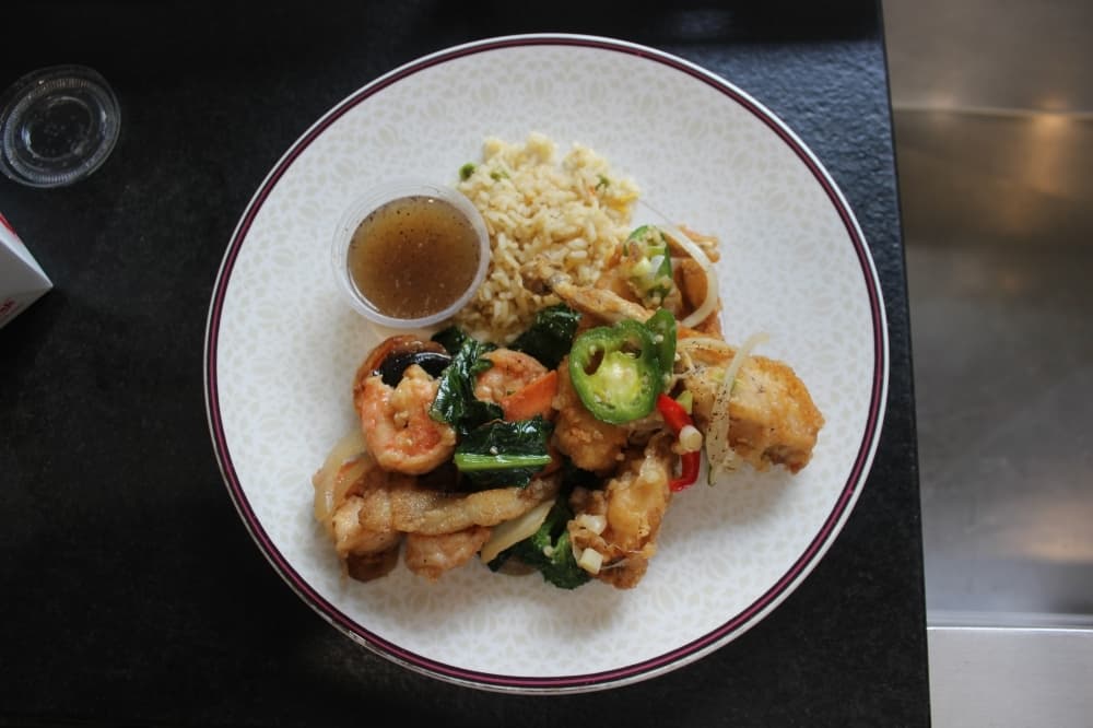 Red Lotus Asian Grille  serves lightly breaded frog legs served with lemon pepper sauce and fried rice on the side. (Sumaiya Malik/Community Impact Newspaper)