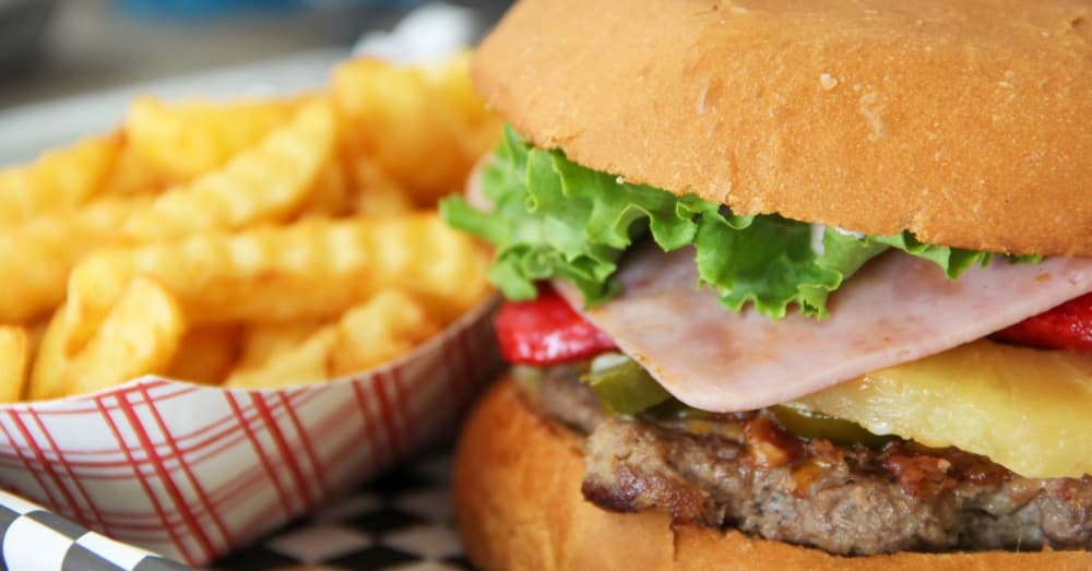 The Piccolo Combo ($12): An Angus beef burger is piled high with jalapenos, shredded cheese, ham, mayo, mustard, lettuce, tomatoes and onions. (Wesley Gardner/Community Impact Newspaper)