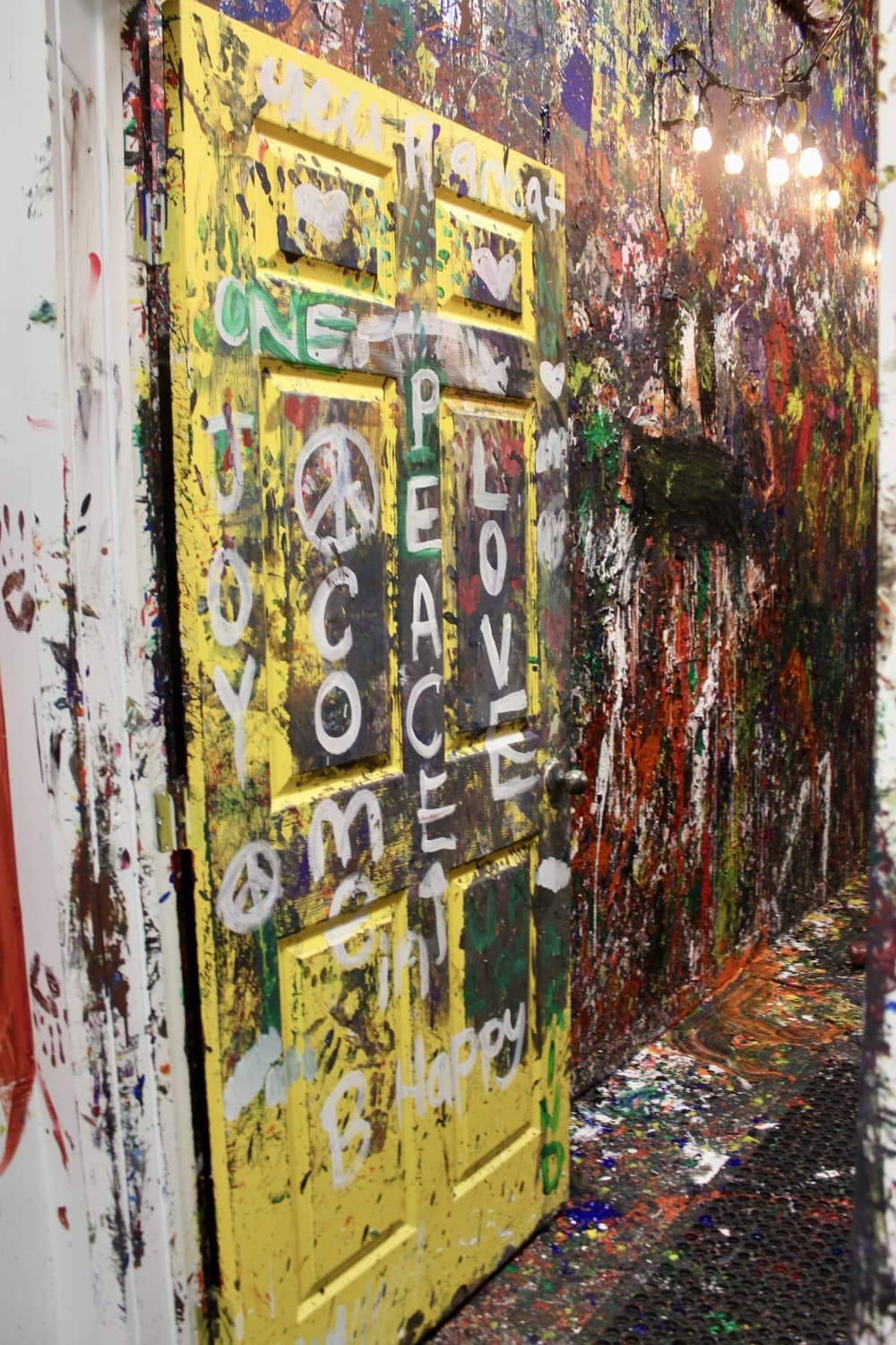 The Breaking Point provides the paint and canvas in the splash room. Customers are free to splash on the walls, or the floor, or even dip their hands in paint and mess up the walls. (Sumaiya Malik/Community Impact Newspaper)