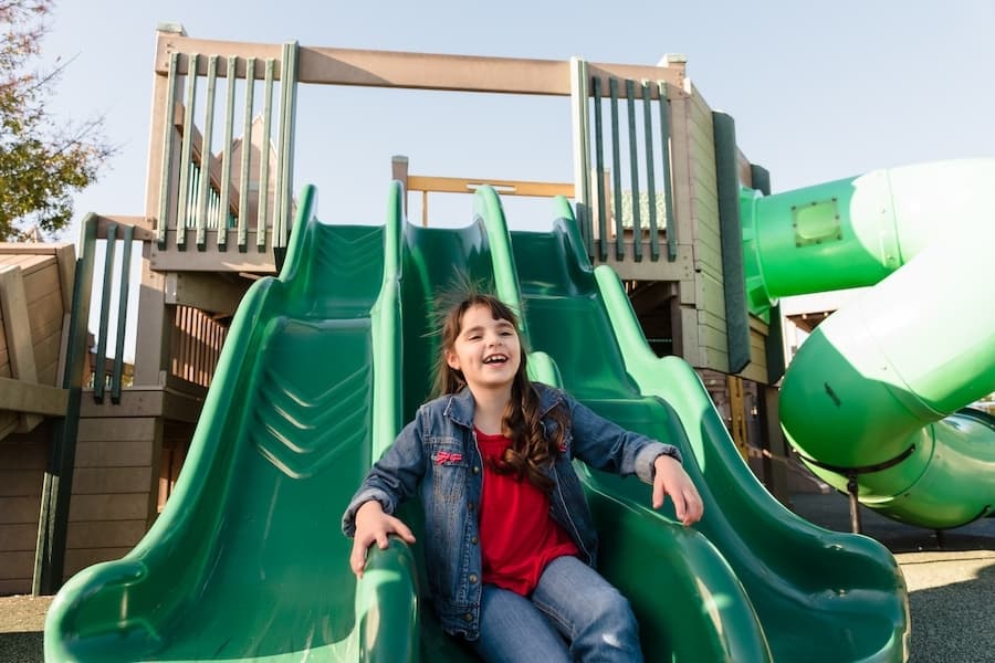 girl on a slide at the park