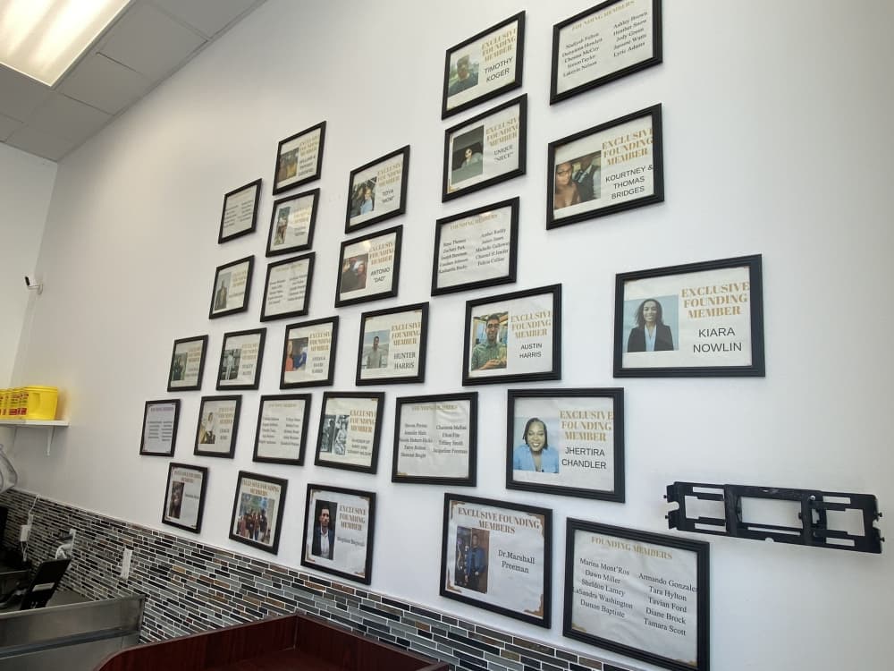 The donor wall displays the names and pictures of people who donated toward Cranky Granny's when the doors first opened at the Domain. (Sumaiya Malik/Community Impact Newspaper)
