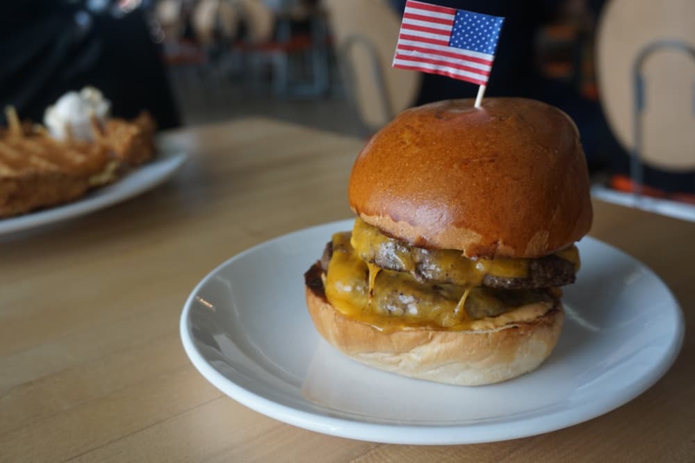 LK Burger ($11)—A double-meat burger is topped with cheddar, pickles and secret sauce on a challah bun from Cake & Bacon. (Mikah Boyd/Community Impact Newspaper)