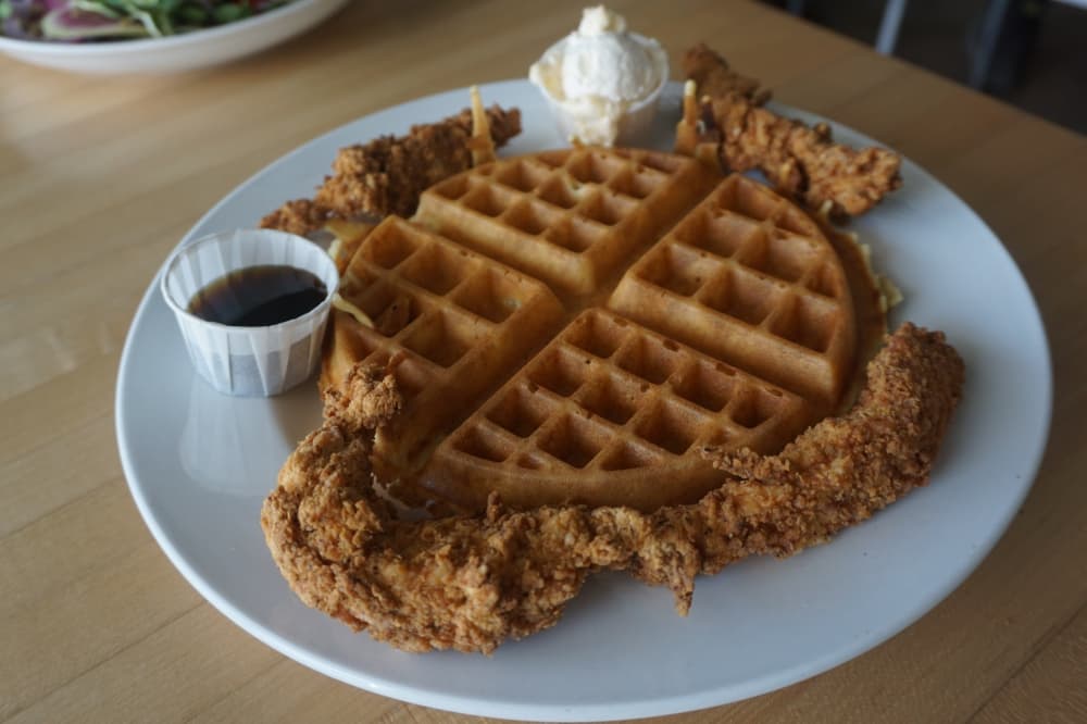 Chicken ‘n’ waffles ($12)—This entree is served with maple syrup and honey butter. (Mikah Boyd/Community Impact Newspaper)