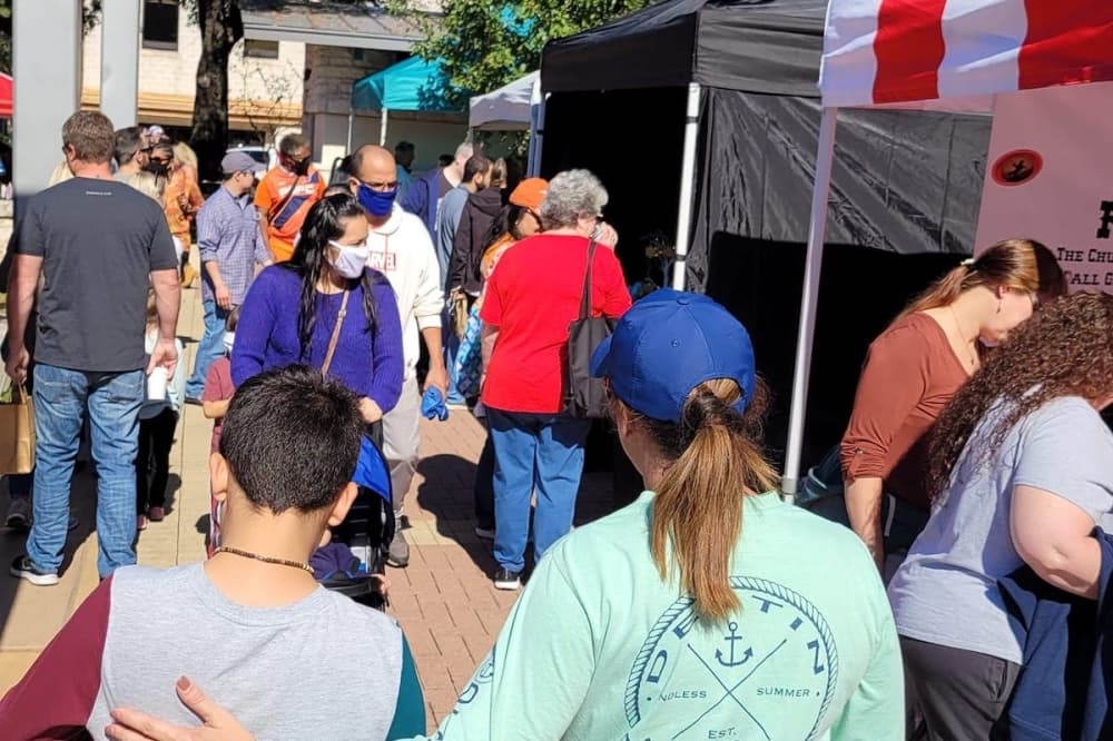 people walking by tents