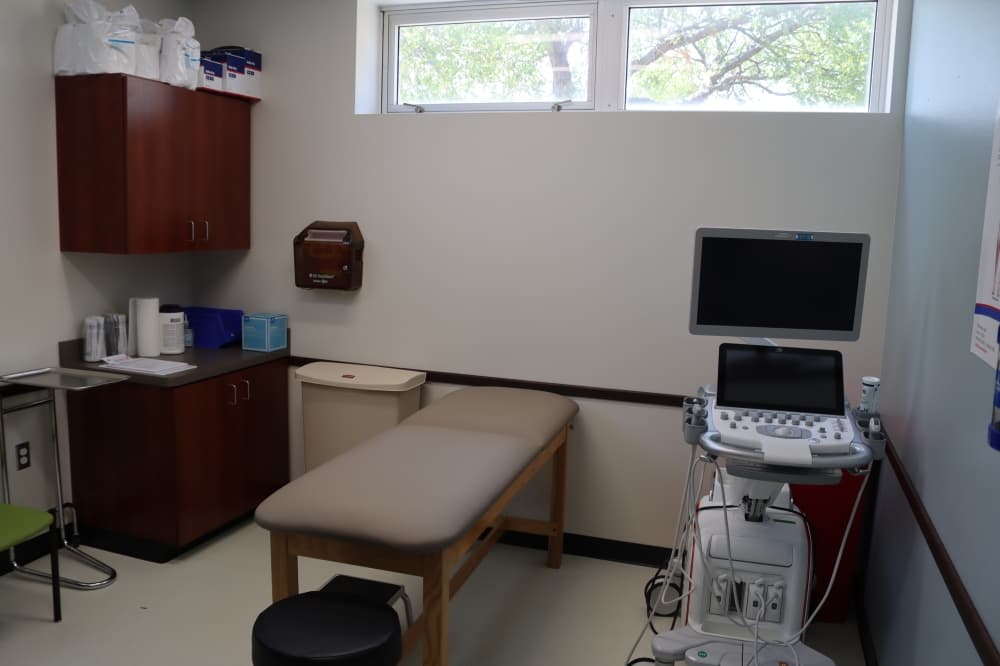 The clinic features five exam rooms featuring different medical equipment. The room pictured has an ultrasound system. (Grant Johnson/Community Impact Newspaper)