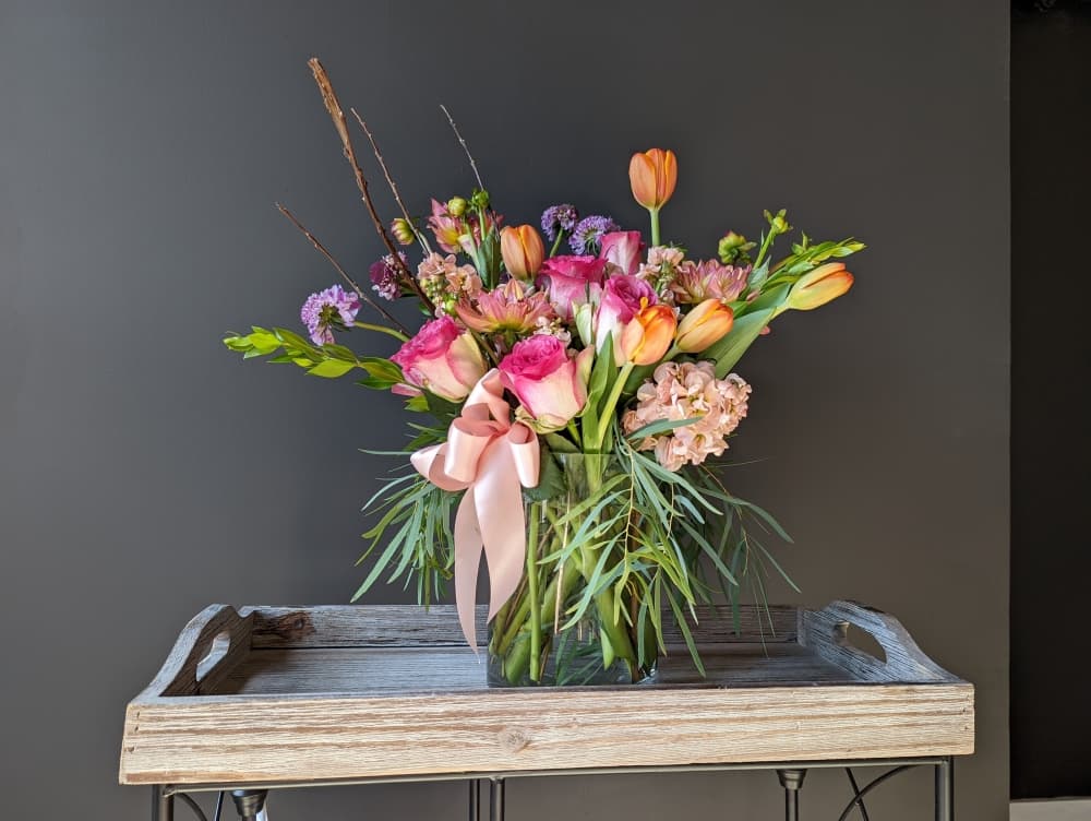
An arrangement features double tulips, scabiosa, roses and stock.