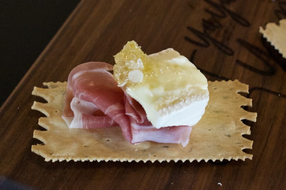 Owner Ayesha Patel said she likes to create perfect bites, like this one featuring brie, honeycomb and prosciutto. (Hannah Johnson/Community Impact Newspaper)