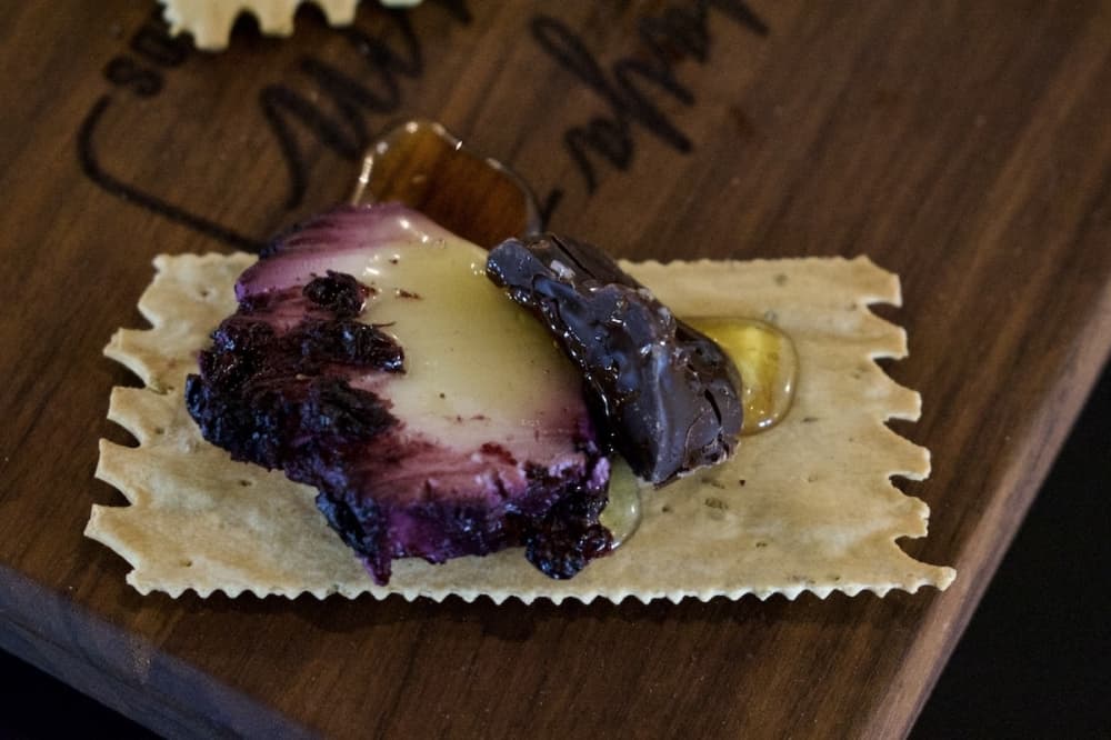 This combination of flavors used in YaYaYum Board's charcuterie boards includes blueberry vanilla goat cheese, dark chocolate and honey. (Hannah Johnson/Community Impact Newspaper)