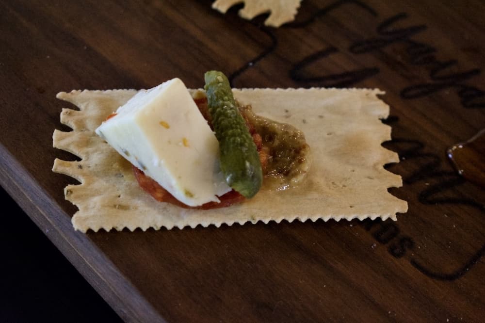 Jalapeno cheddar, soppressata and cornichons combine to make this perfect bite, owner Ayesha Patel said. (Hannah Johnson/Community Impact Newspaper)