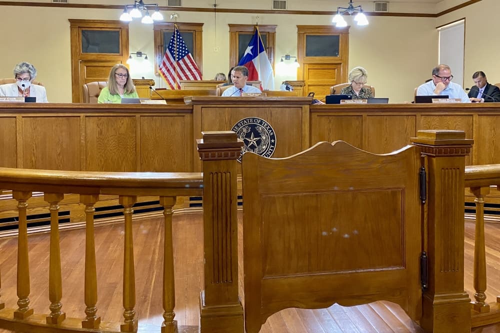 Five people behind a dias