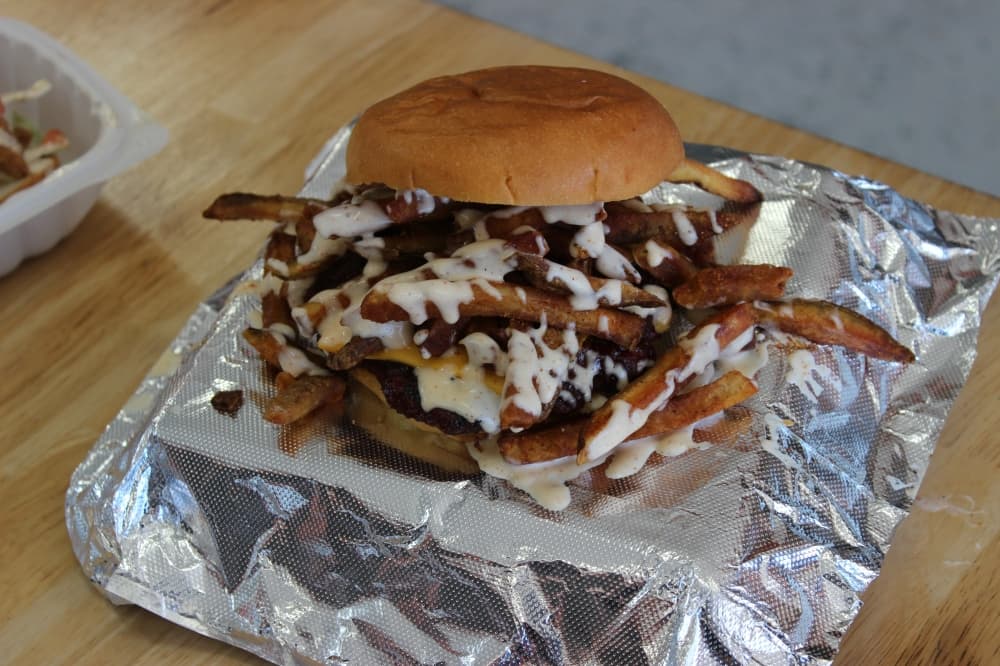Kretzschy’s menu features the Big Easy ($9.50), which is a cheeseburger topped with Cajun fries and white sauce. (Destine Gibson/Community Impact Newspaper)