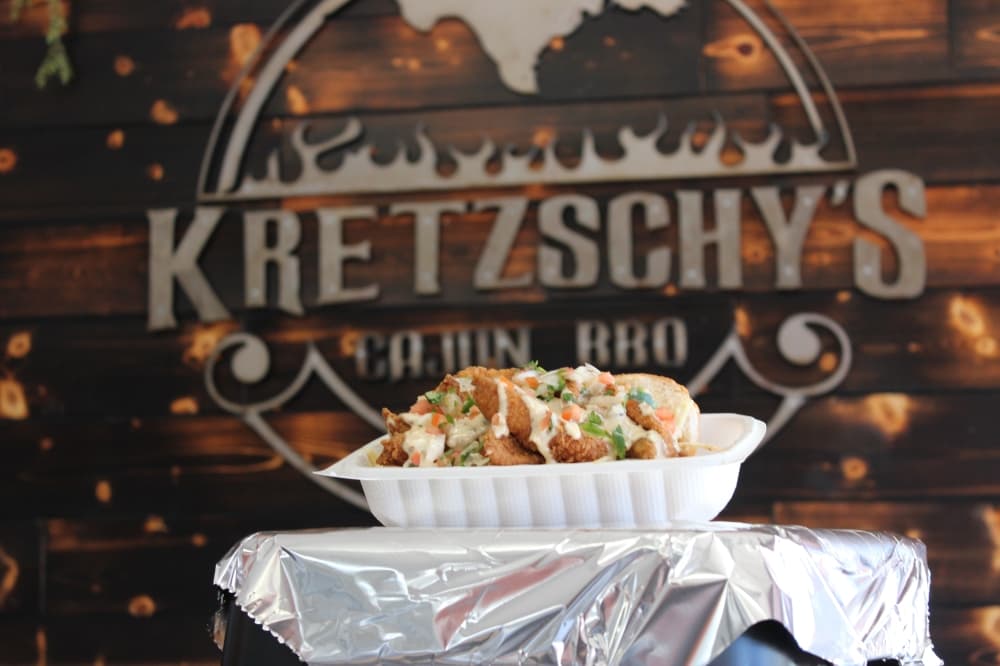 The catfish po’boy ($10.75) includes fried, hand-breaded catfish tenders on a toasted French baguette served with pico de gallo, slaw and house sauces. (Destine Gibson/Community Impact Newspaper)