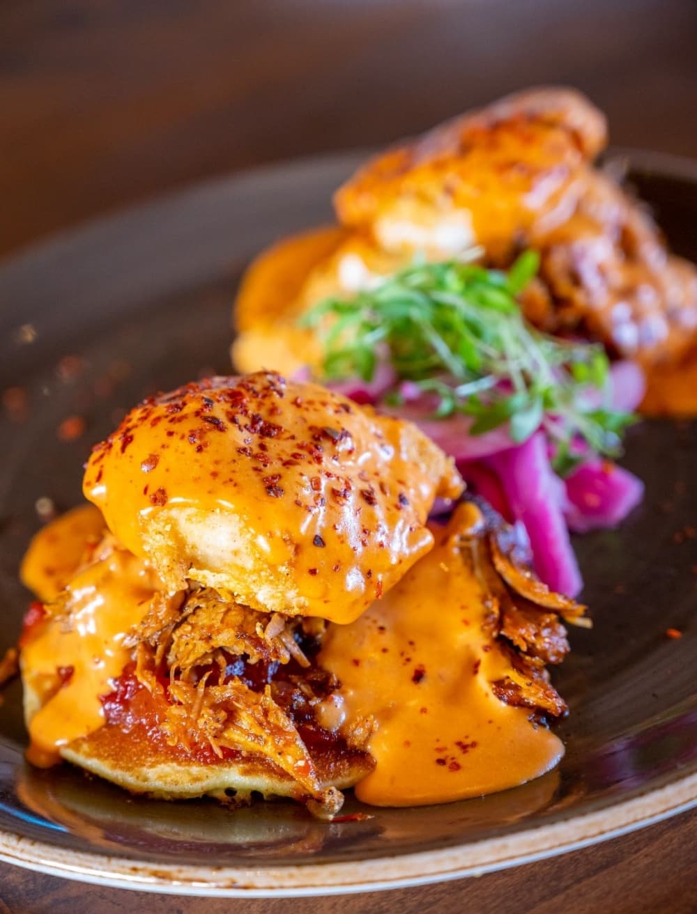 Mexican Eggs Benedict served at La Cosecha Mexican Table includes a Jalapeño cornmeal pancake, tomato jam, poached eggs lightly breaded and fried, cochinita pibil and guajillo hollandaise. $17.95 (Kody Melton/La Cosecha Mexican Table)