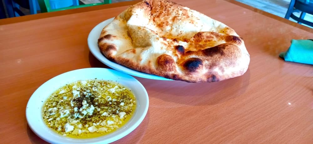 Diners at Basil Mediterranean Kitchen may enjoy complimentary naan with a blend of olive oil, feta cheese and Persian spices. (Edmond Ortiz/Community Impact Newspaper)
