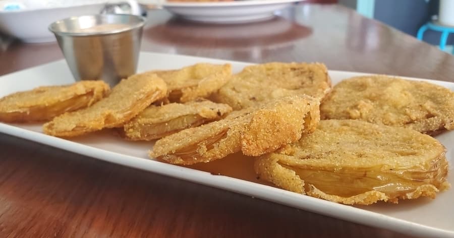 The fried green tomatoes ($0.99) are one of the popular side dishes at Happy Day Café. (Jarrett Whitener/Community Impact Newspaper)