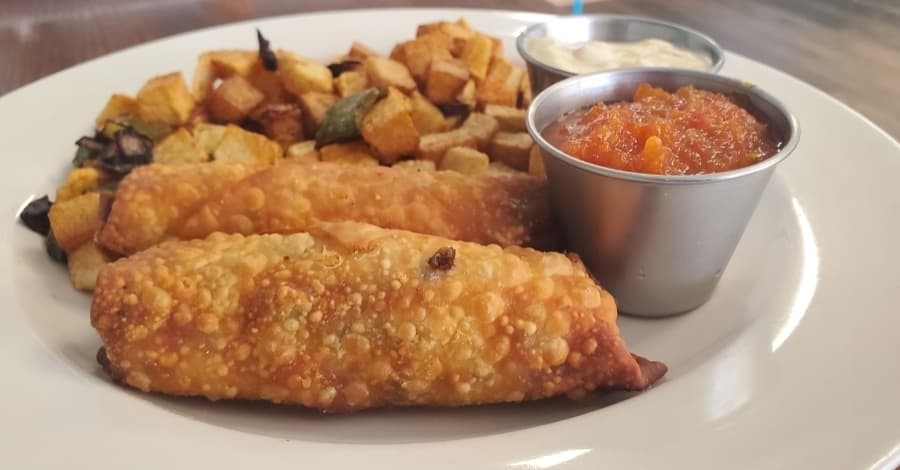 The scrambled egg rolls ($0.99) are stuffed with eggs, sausage, bacon, peppers and onions. (Jarrett Whitener/Community Impact Newspaper)