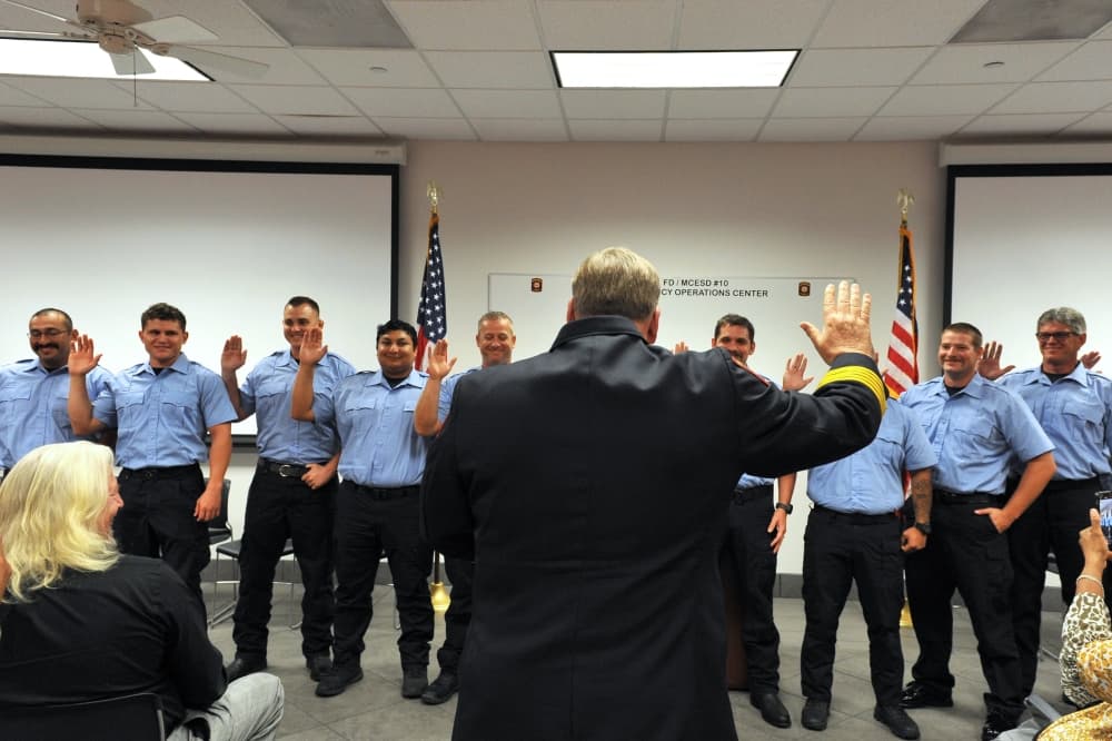 Fire Chief Jeff Hevey swears in the 12 new firefighters. (Courtesy Lt. Walter Sassard/Magnolia Fire Department)