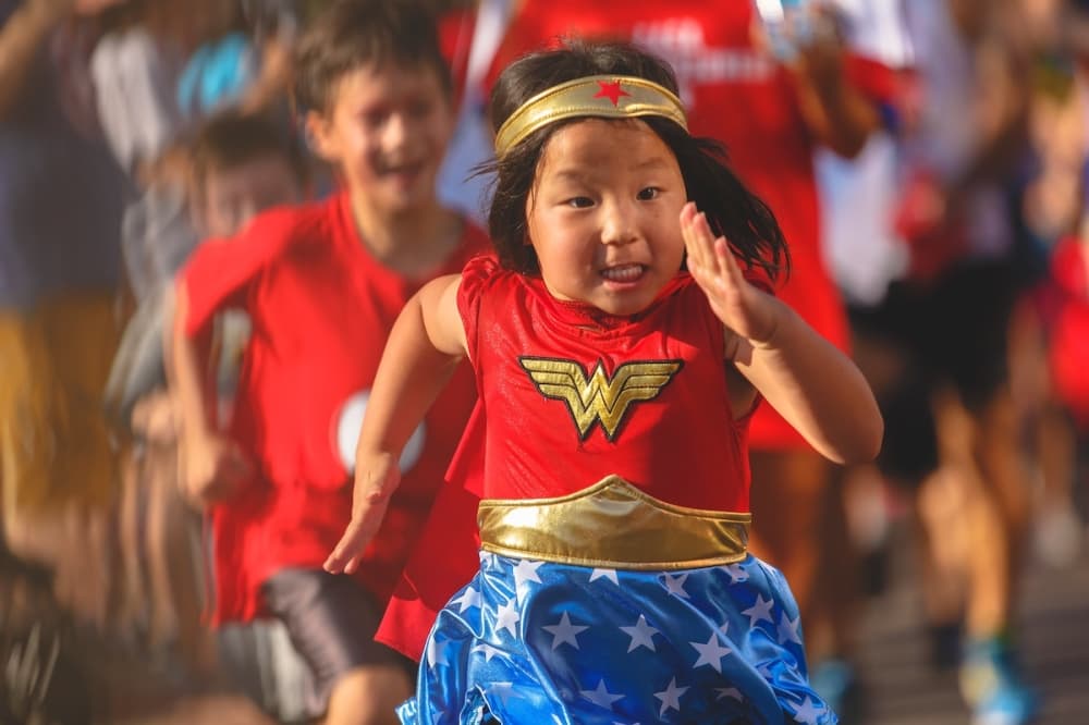 little girl in superhero costume