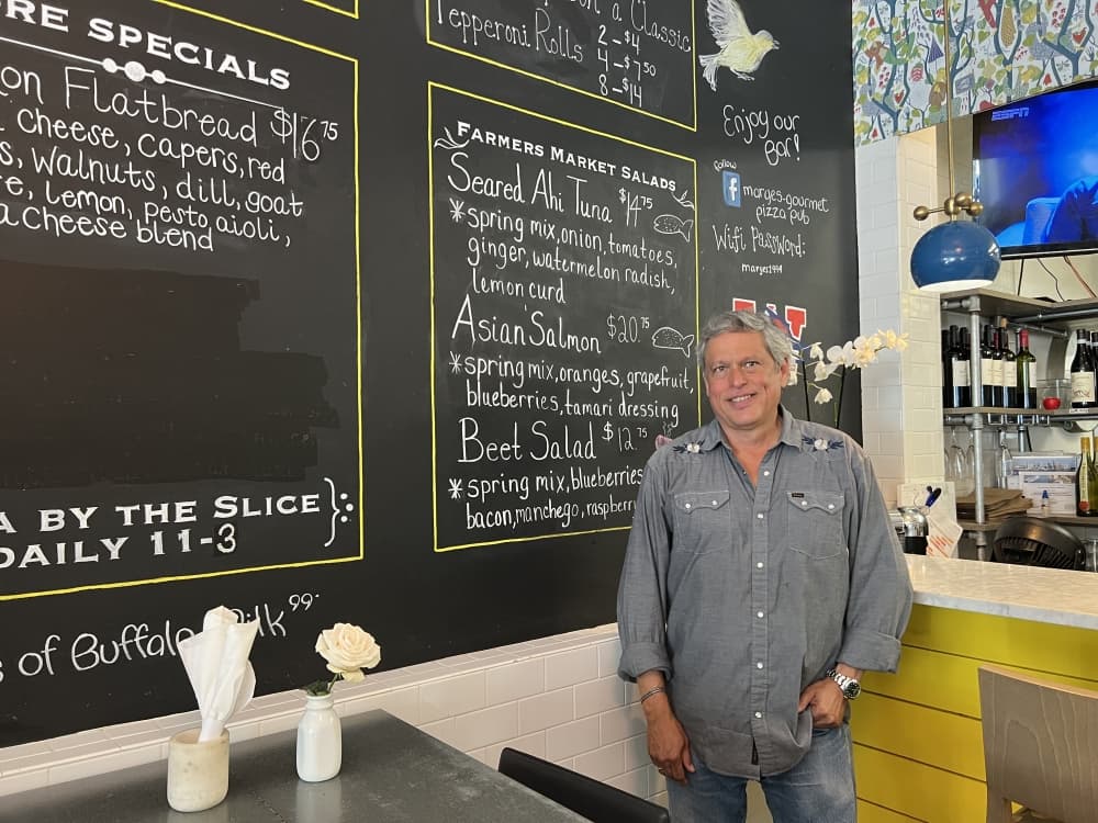 man in front of menu board