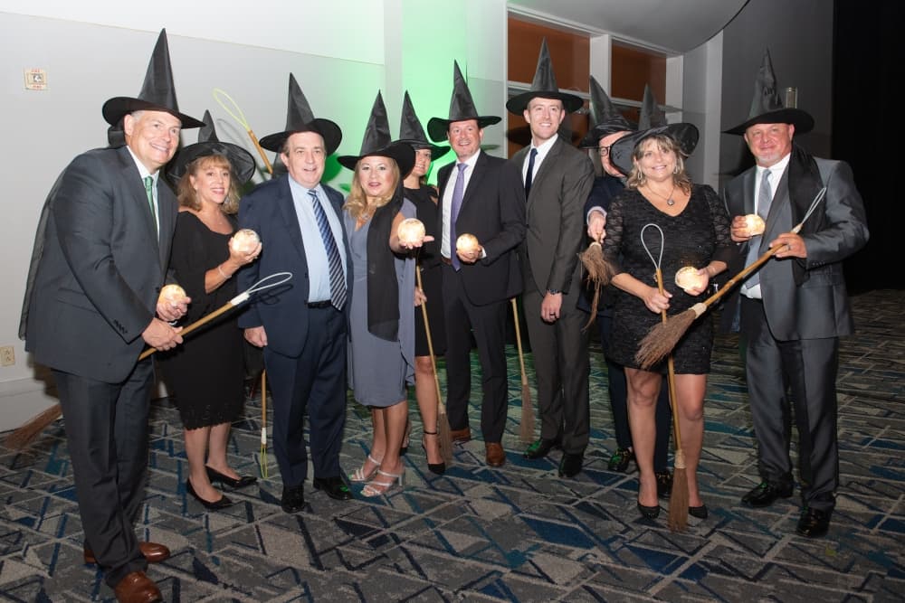 Attendees donned witch hats in keeping with “The Wizard of Oz”-themed Chairman's Ball event. (Courtesy Tara Flannery Photography)