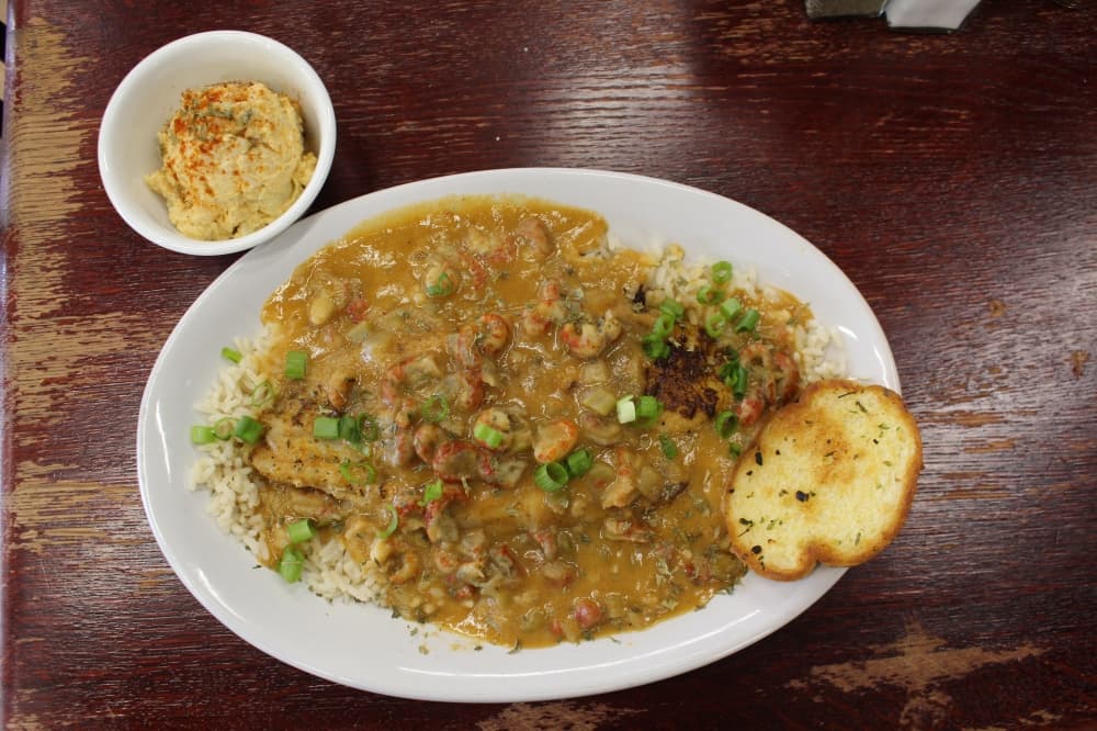 Catfish Atchafalaya ($15.25) is a blackened catfish filet smothered with crawfish etouffee and served over rice with garlic bread and potato salad. (Kayli Thompson/Community Impact Newspaper)