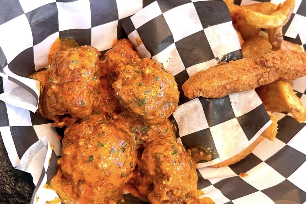 Fried cauliflower bits shown in The Dirty Bird spicy garlic parmesan Bird Bath. (Zacharia Washington/Community Impact Newspaper) 
