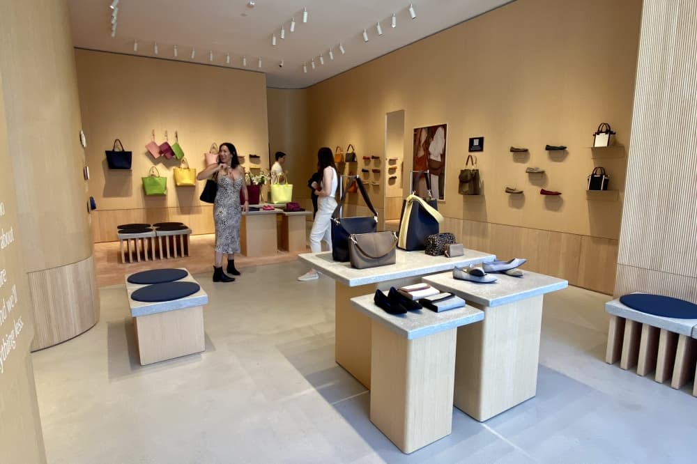 Inside of a store with shoes displayed on the walls
