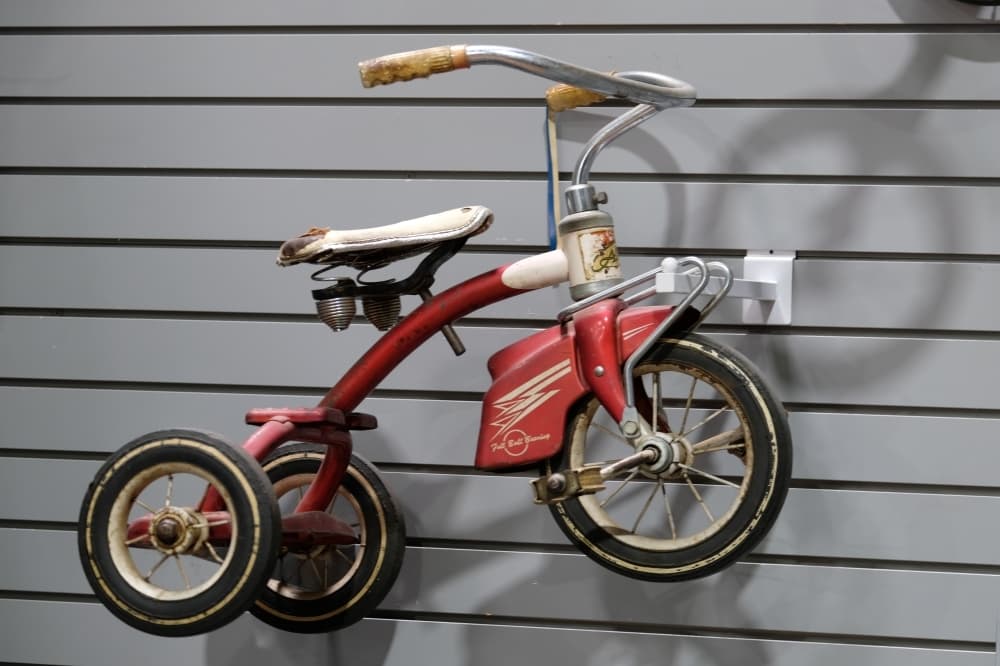 
An antique red tricycle is on display. 