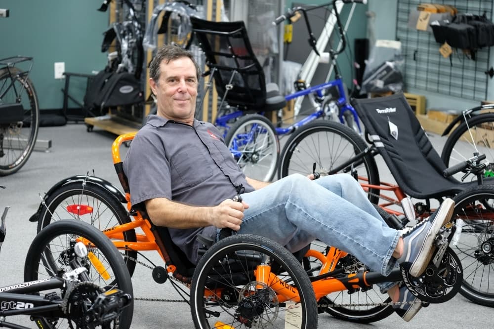 
Planetary Cycles owner Adam Potter sits on a recumbent bike.