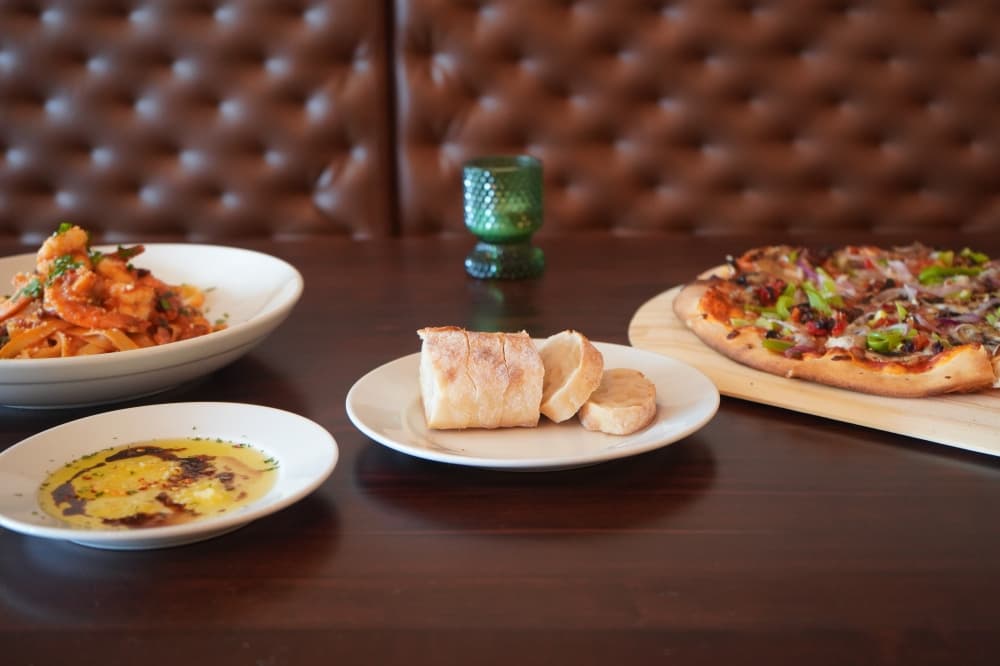 Bread and Italian butter is brought to the table as part of the meal. (Christopher Goodwin/Community Impact Newspaper)