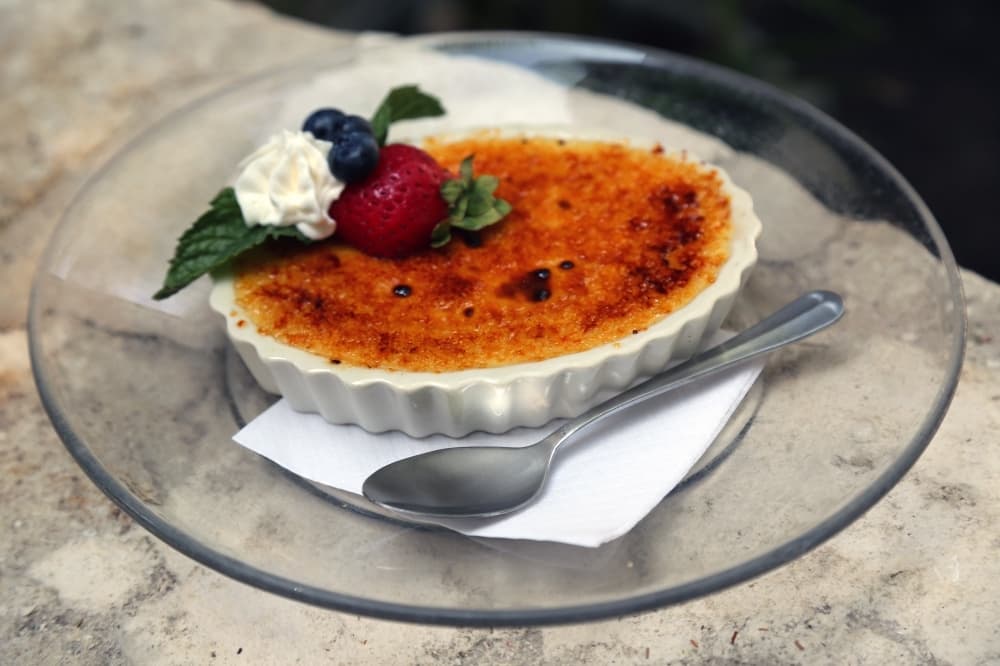 The creme brulee ($7.50) comes with vanilla bean topped with fresh strawberries and blueberries. (Courtesy Huisache Grill)