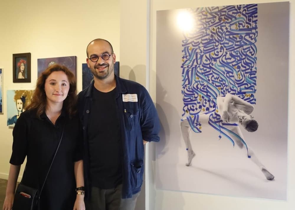 Ashkan Roayaee (right), stands beside his piece titled "Nava" at the Archway Gallery. (Courtesy Archway Gallery)
