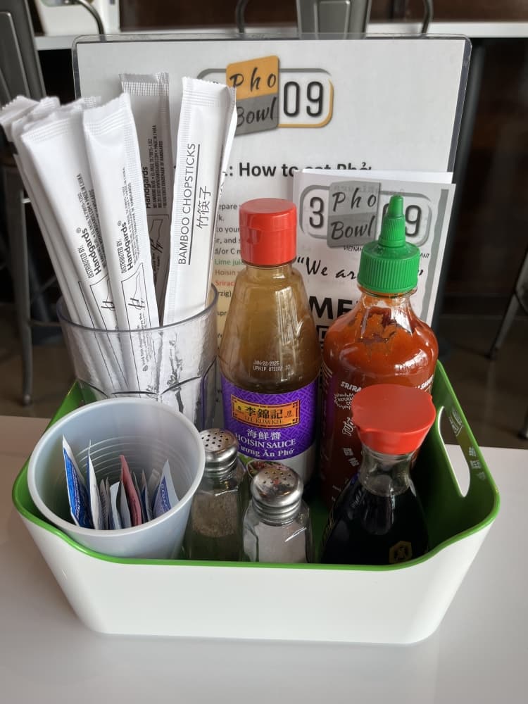 Condiments included on teach table include hoisin sauce, soy sauce and sriracha so that diners can personalize their dishes. (Tricia Schwennesen/Community Impact Newspaper)