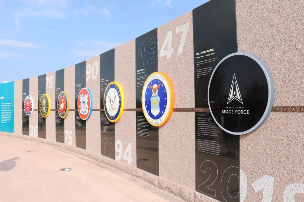 A wall features the seals of each of the seven branches of government. (Zara Flores/Community Impact Newspaper)