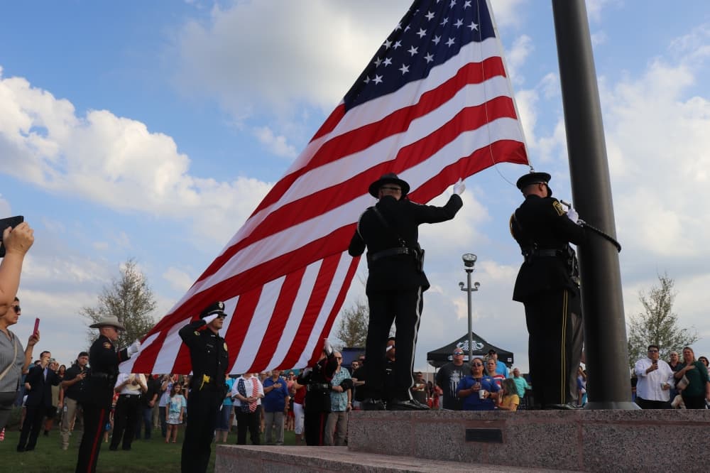 The raising of the flag ceremony was performed by Kyle and San Marcos police officers. (Zara Flores/Community Impact Newspaper)