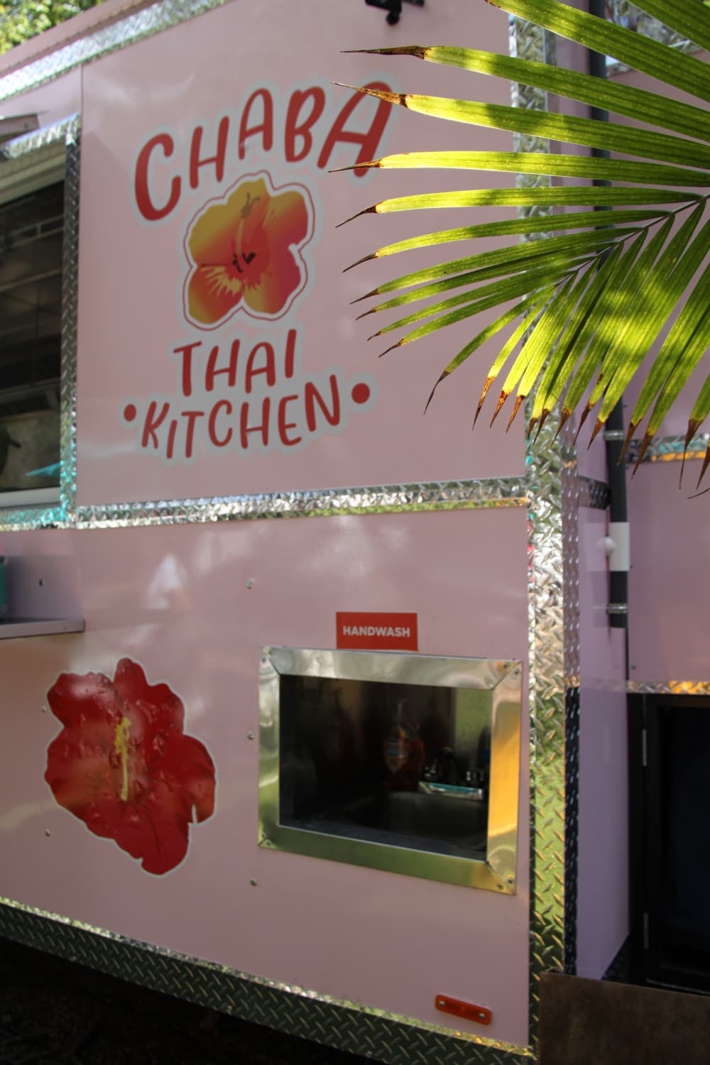 Customers can wash hands in a sink window on the front left wall of the food truck. (Sumaiya Malik/Community Impact Newspaper)