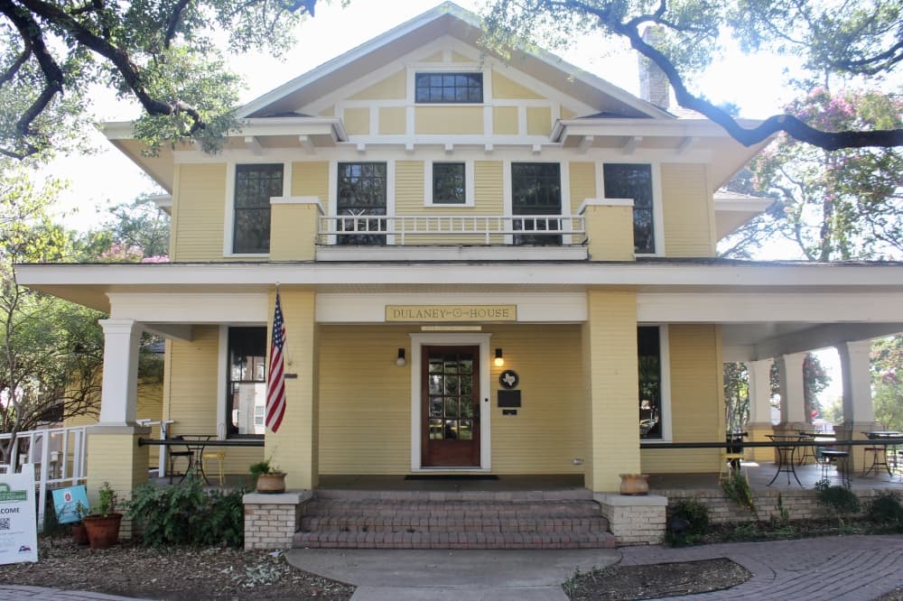 Front exterior of the historic Dulaney House with a name sign over the entry way.