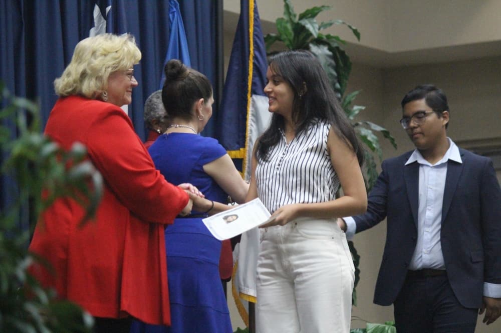 New U.S. citizens receive certificates of citizenship, congratulated by Tomball Mayor Lori Klein Quinn (left) and other Harris County officials. (Anna Lotz/Community Impact Newspaper)