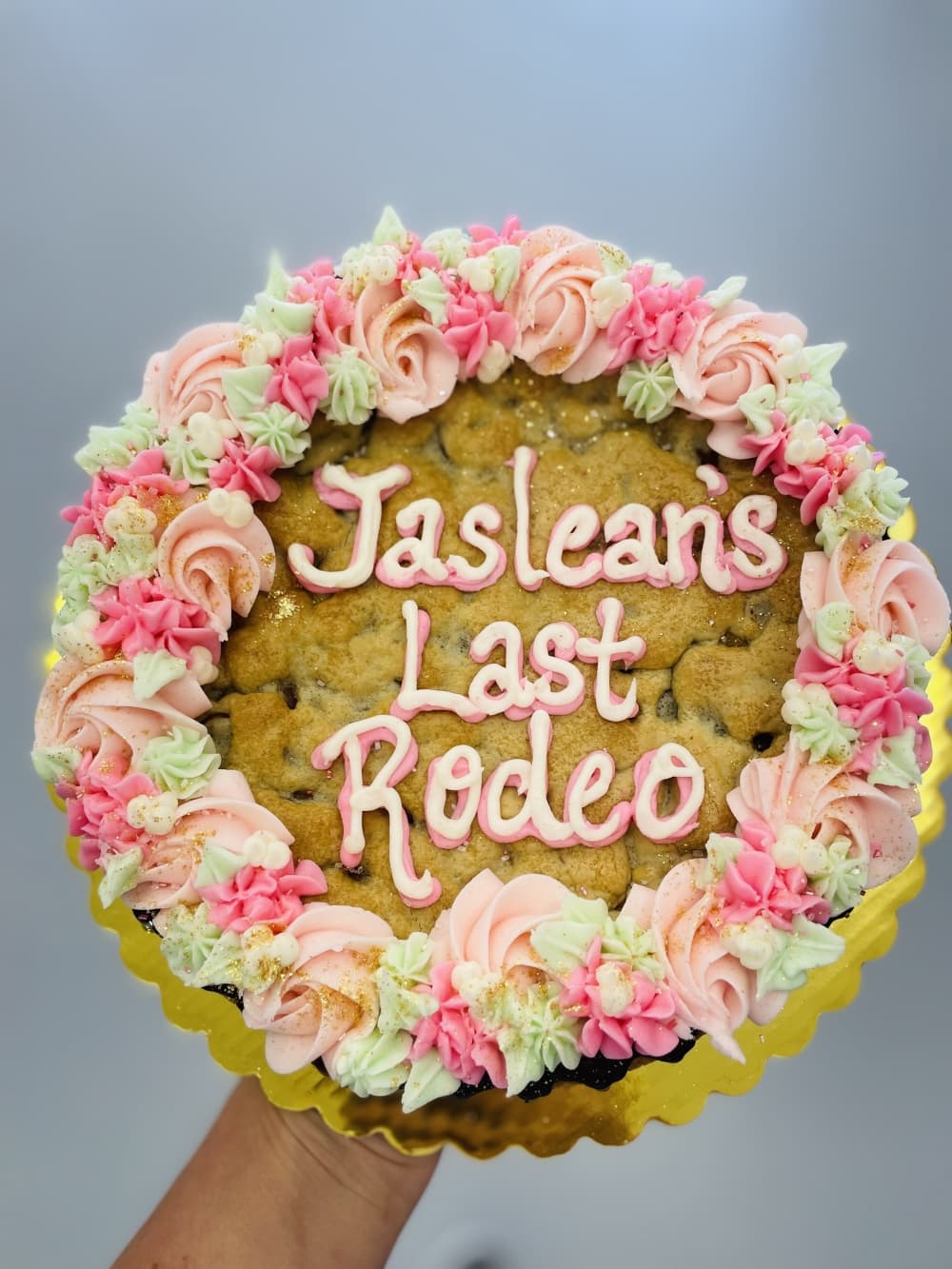 cookie cake with pink rose frosting 