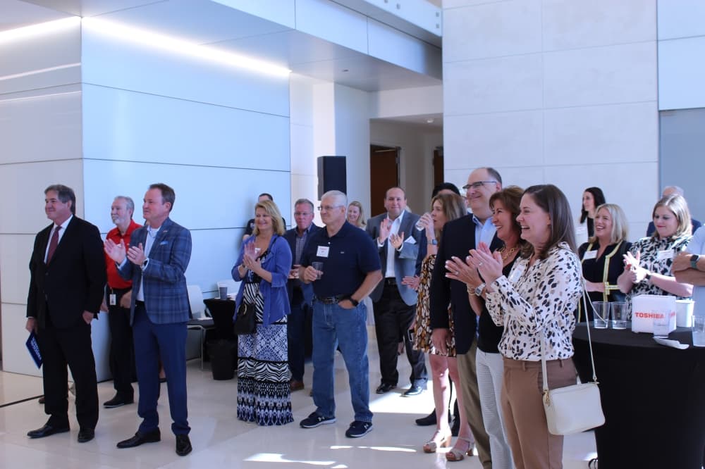 City officials and Toshiba executives listen to Frisco Mayor Jeff Cheney speaking during the ribbon-cutting ceremony Sept. 22. (Colby Farr/Community Impact Newspaper)