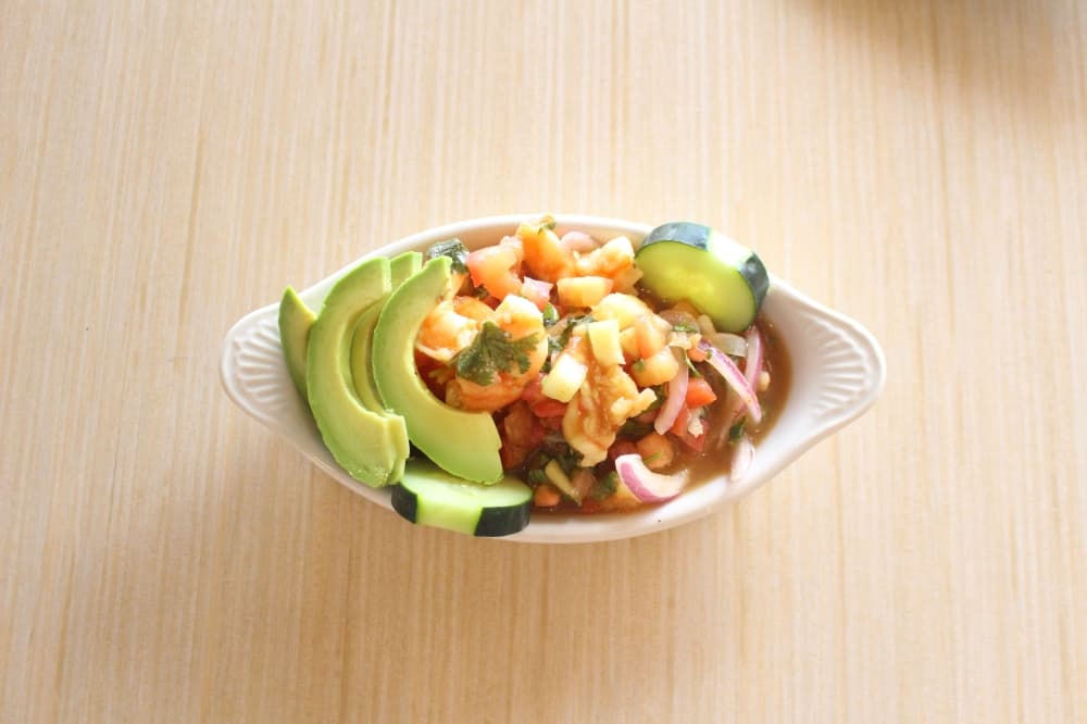 Shrimp Ceviche ($7.99-$9.99) is shrimp marinated in lime juice with fresh herbs, diced tomatoes, onions, cucumbers and avocados. (Lizzy Spangler/Community Impact Newspaper)