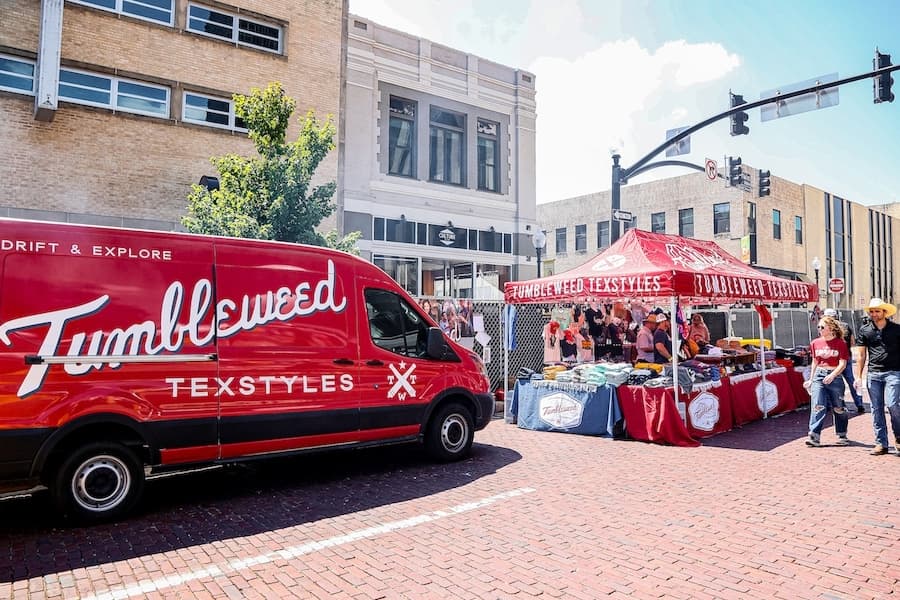 tumbleweed texstyles van and booth outside in downtown frisco, texas