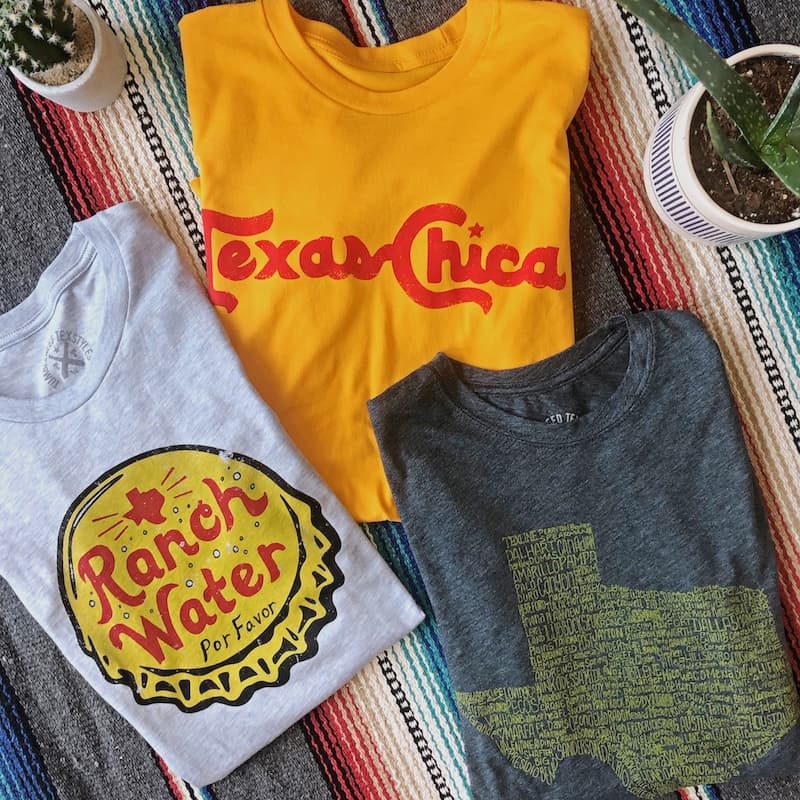 three texas t-shirts on a table